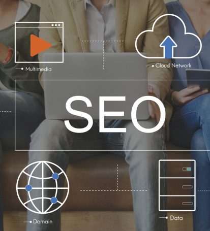 Small business owners sitting, surrounded by digital icons representing SEO concepts like keywords, website traffic, and a magnifying glass, symbolizing online visibility and search engine optimization.