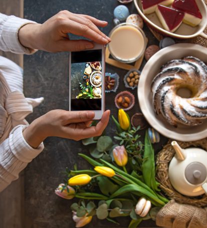 Small business owner takes picture of food for her Instagram to gain more followers quickly.