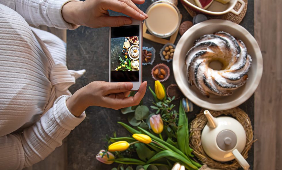 Small business owner takes picture of food for her Instagram to gain more followers quickly.