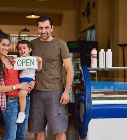 Small business owners stand in front of new opening store powered by A Marketing Space.